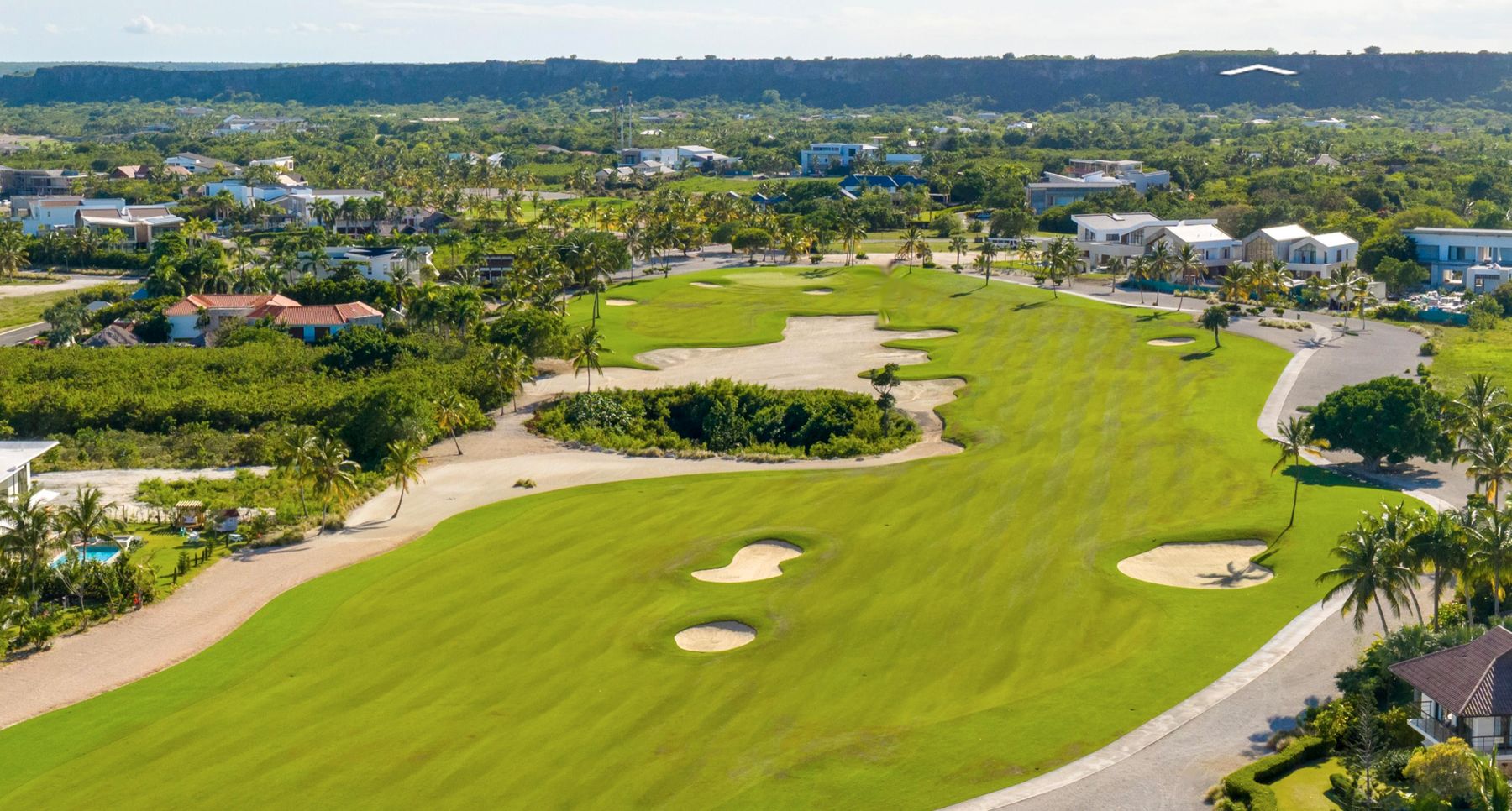 Aerial view down the Punta Espada fairway toward the green and the Cap Cana ridge